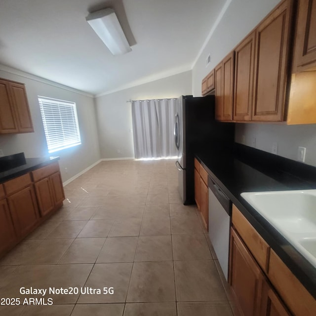 1829 E Adams St, Phoenix, AZ 85034 - kitchen featuring light tile patterned flooring, dishwasher, brown cabinets, dark countertops, and lofted ceiling