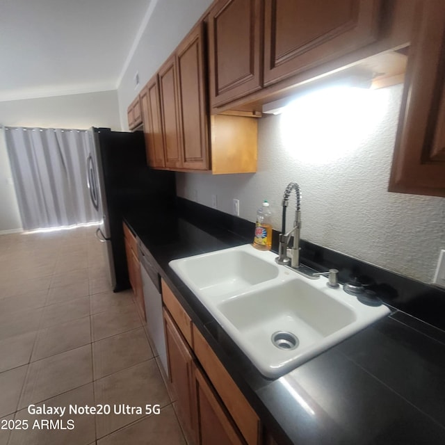1829 E Adams St, Phoenix, AZ 85034 - kitchen with light tile patterned flooring, a sink, brown cabinets, white dishwasher, and dark countertops