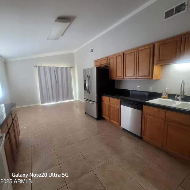 1829 E Adams St, Phoenix, AZ 85034 - kitchen with a sink, appliances with stainless steel finishes, brown cabinets, dark countertops, and visible vents