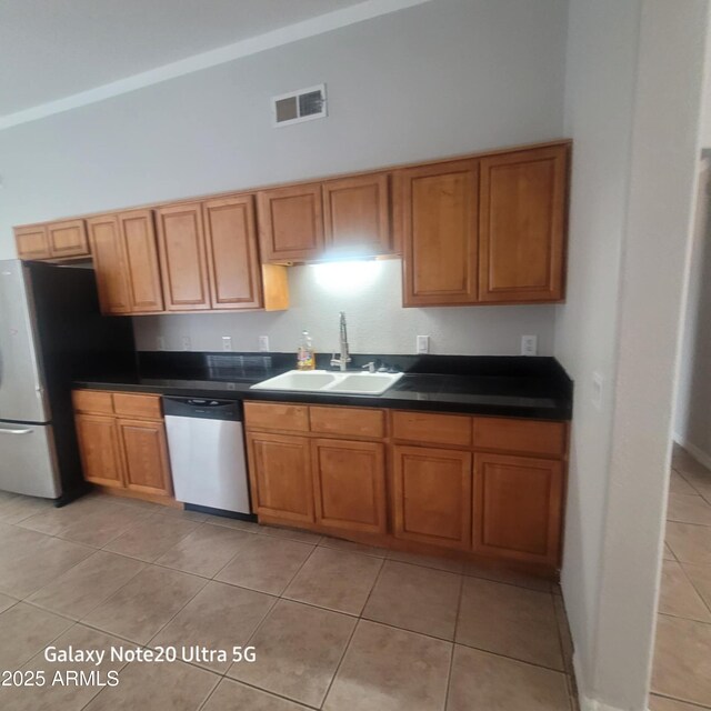 1829 E Adams St, Phoenix, AZ 85034 - kitchen with a sink, stainless steel appliances, and brown cabinetry
