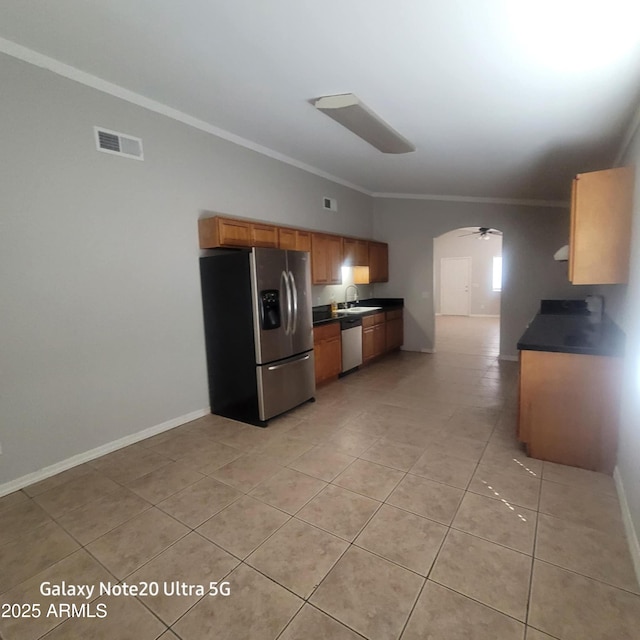 1829 E Adams St, Phoenix, AZ 85034 - kitchen with visible vents, crown molding, dark countertops, appliances with stainless steel finishes, and arched walkways
