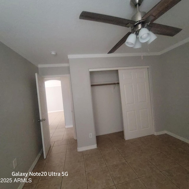 1829 E Adams St, Phoenix, AZ 85034 - unfurnished bedroom with tile patterned floors, a closet, baseboards, and ornamental molding