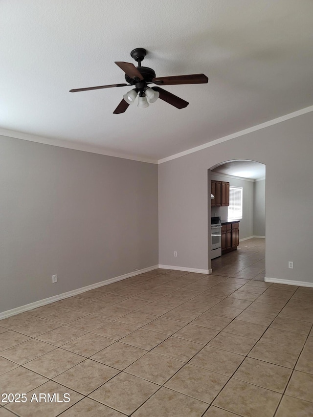 1829 E Adams St, Phoenix, AZ 85034 - empty room featuring crown molding, baseboards, a ceiling fan, arched walkways, and light tile patterned floors