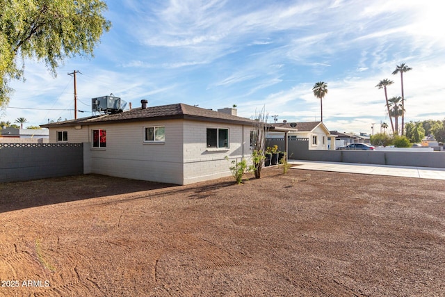 rear view of property featuring cooling unit and a patio