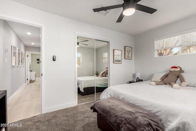 carpeted bedroom with a closet and ceiling fan