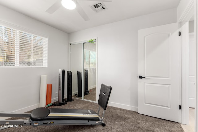 exercise area with ceiling fan and carpet floors