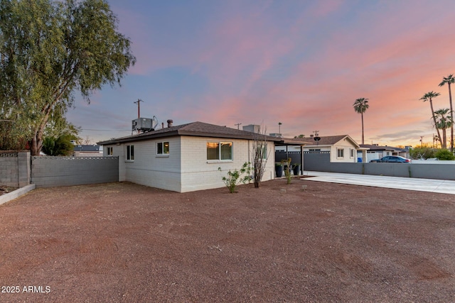 ranch-style home with cooling unit and a patio