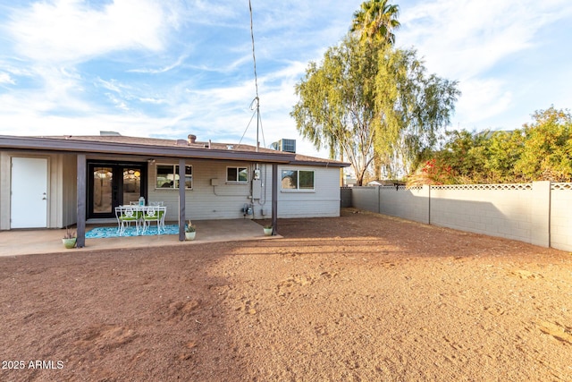 back of house featuring central AC unit and a patio area