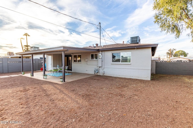 back of house with central AC unit and a patio