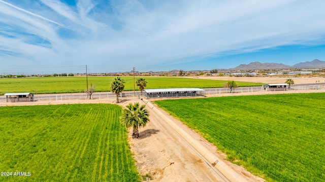 exterior space with a lawn, a mountain view, and a rural view