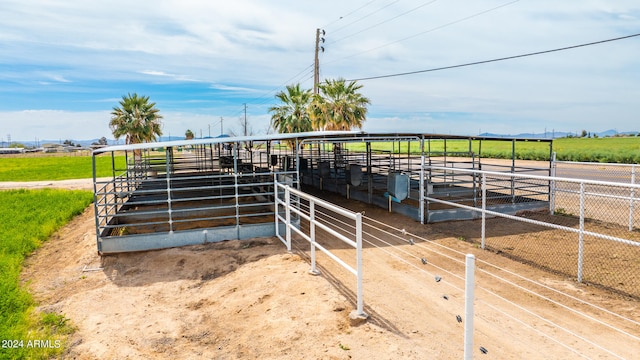 view of horse barn with an outdoor structure and a rural view