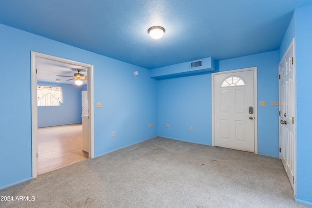 spare room with ceiling fan, carpet floors, and a textured ceiling