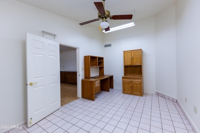 interior space featuring ceiling fan and light tile flooring