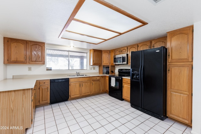 kitchen with sink, black appliances, and light tile floors