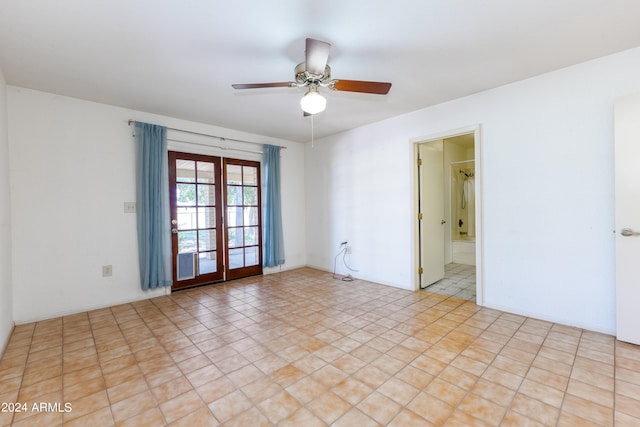 tiled empty room with ceiling fan and french doors