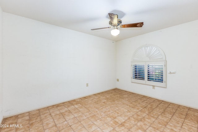 spare room featuring ceiling fan and light tile flooring