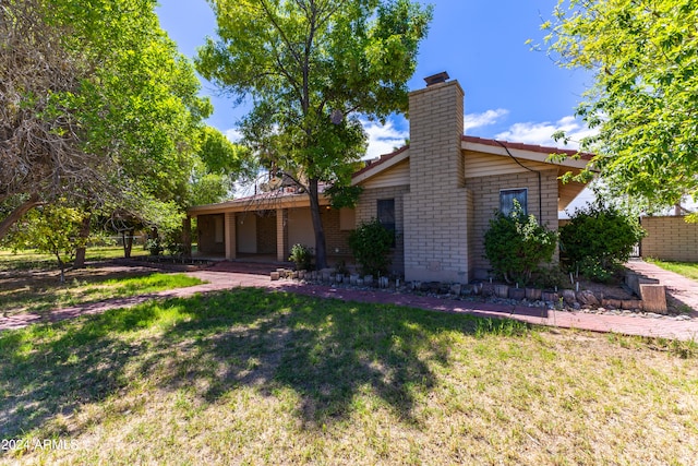 rear view of property with a yard