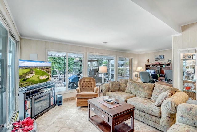 living room with a healthy amount of sunlight, crown molding, and light tile patterned flooring