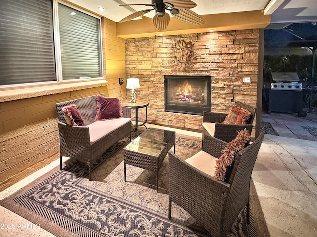 view of patio with a ceiling fan, a grill, and an outdoor living space with a fireplace