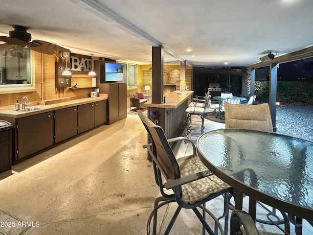 interior space featuring ceiling fan and finished concrete flooring