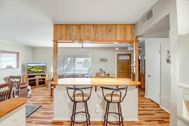 kitchen featuring light wood-type flooring, visible vents, and a healthy amount of sunlight