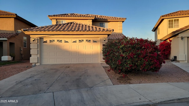 mediterranean / spanish-style home with a garage