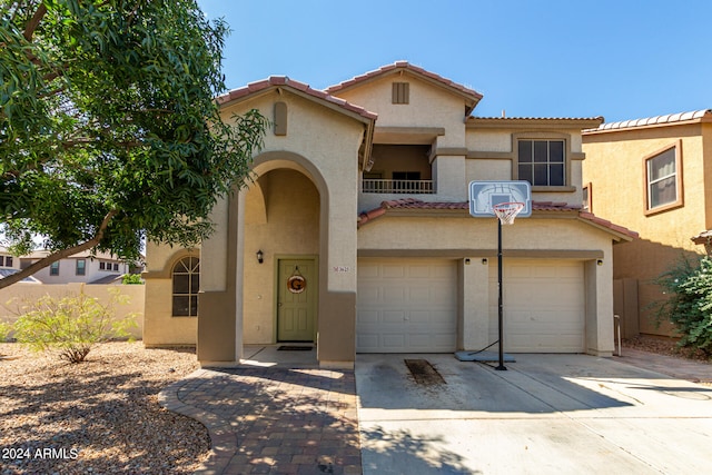 mediterranean / spanish-style house with a garage