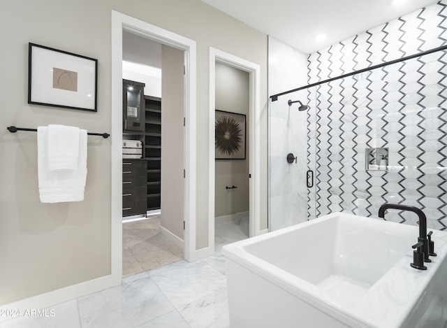 full bathroom with tiled shower, marble finish floor, baseboards, and recessed lighting