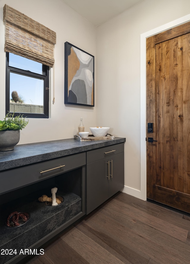 bathroom with wood finished floors, vanity, and baseboards