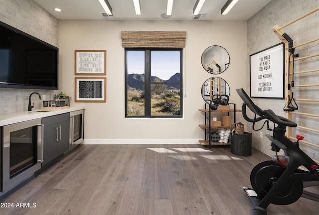 bar featuring wine cooler, a mountain view, visible vents, and a sink