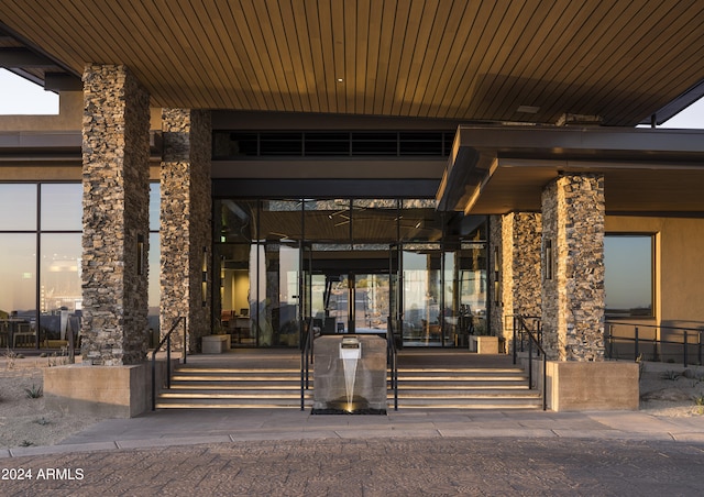 property entrance with stone siding