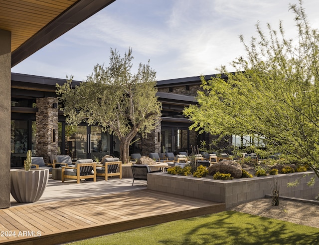 surrounding community with an outdoor living space and a wooden deck
