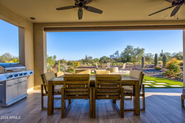 wooden terrace with grilling area and ceiling fan