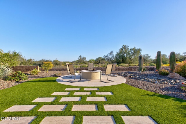 view of yard with a patio and an outdoor fire pit