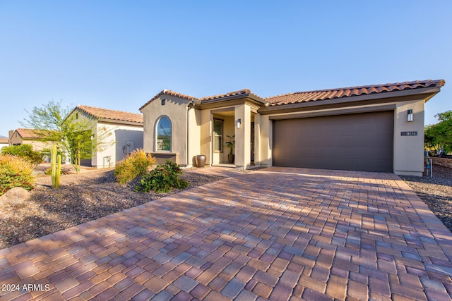 mediterranean / spanish-style home featuring a garage