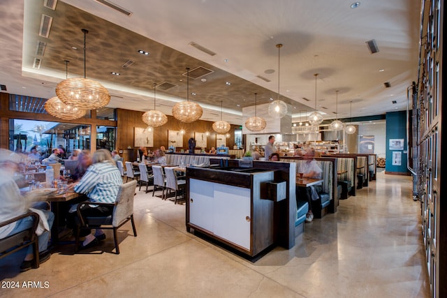 kitchen featuring a tray ceiling and pendant lighting