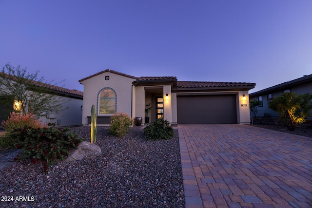 mediterranean / spanish-style home with a garage