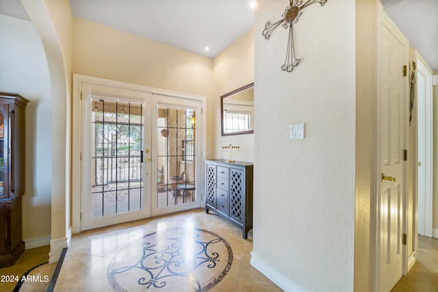 tiled foyer featuring french doors