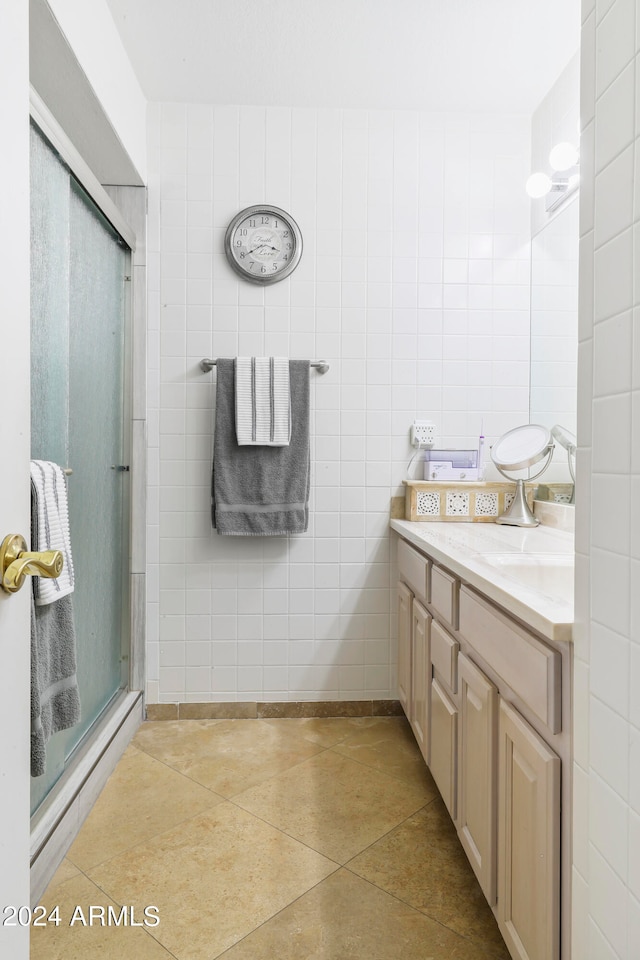 bathroom with walk in shower, tile floors, and vanity