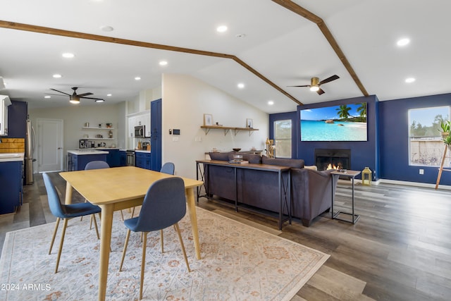 dining room with lofted ceiling with beams, dark hardwood / wood-style flooring, and ceiling fan