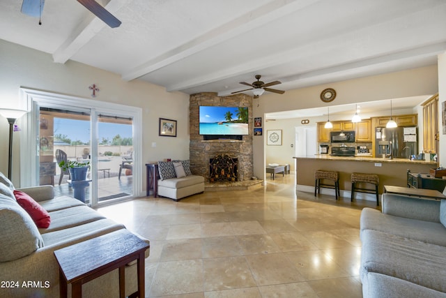 living room featuring ceiling fan, beam ceiling, a fireplace, and light tile floors