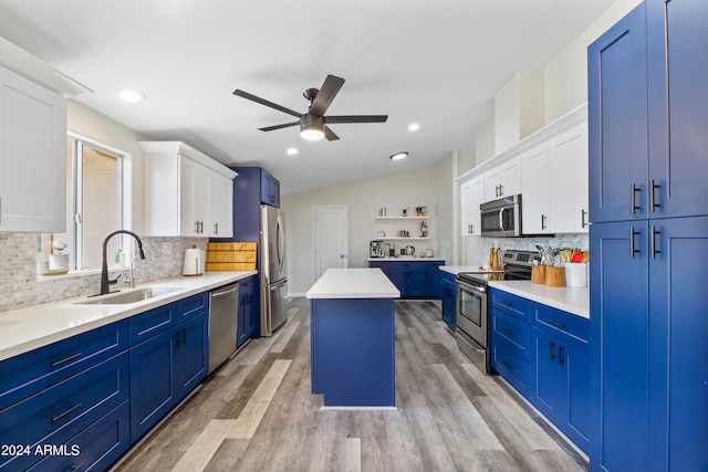 kitchen with a kitchen island, white cabinetry, ceiling fan, and appliances with stainless steel finishes