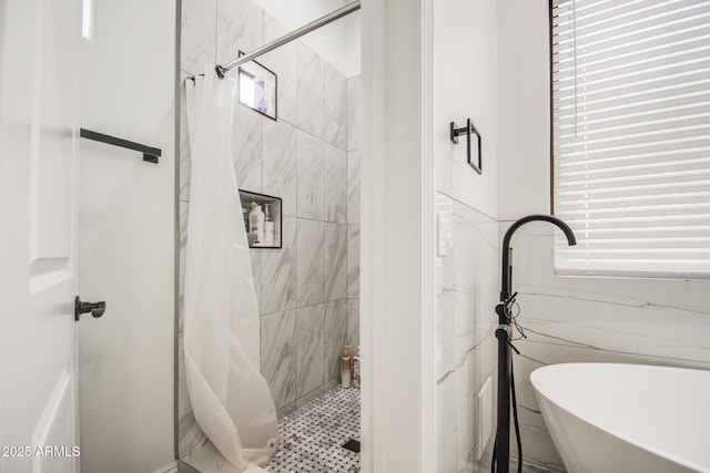 bathroom with a soaking tub and a shower stall