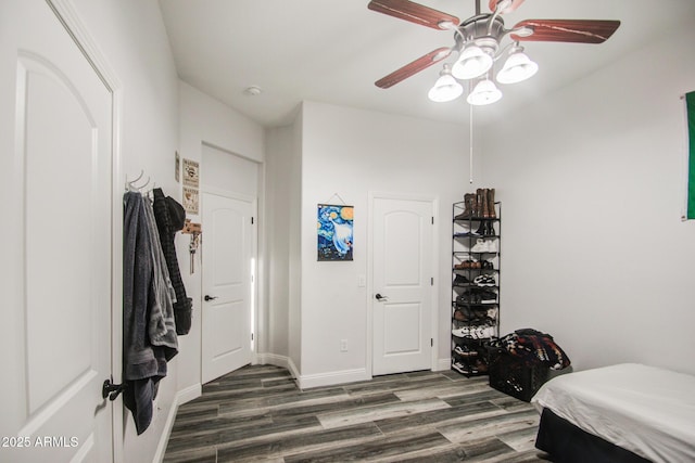 bedroom with ceiling fan, baseboards, and wood finished floors