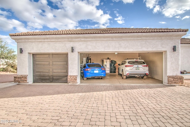 garage featuring decorative driveway