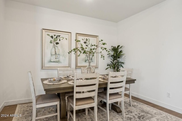 dining room with dark hardwood / wood-style flooring