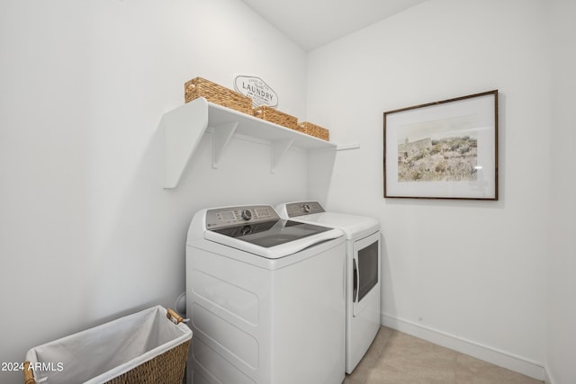 clothes washing area with separate washer and dryer