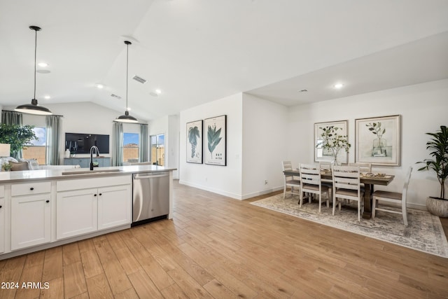 kitchen with white cabinetry, stainless steel dishwasher, light wood-type flooring, and pendant lighting