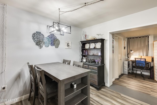 10374 W Deanne Dr, Sun City, AZ 85351 - dining space with an inviting chandelier, baseboards, and light wood-type flooring