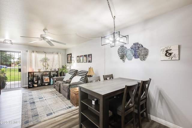 10374 W Deanne Dr, Sun City, AZ 85351 - dining space featuring ceiling fan with notable chandelier, wood finished floors, and baseboards